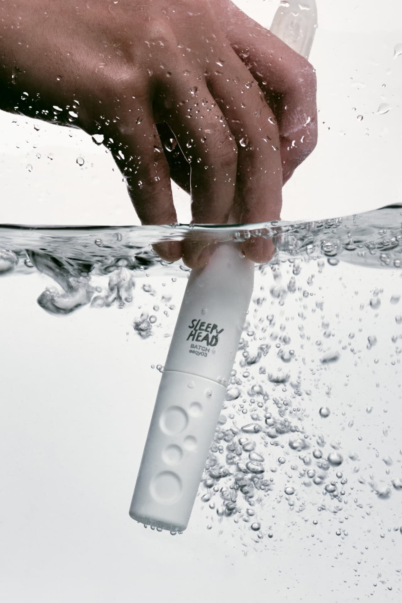 Hand holding LUNA 3D+ underwater showing IPX7 waterproof design